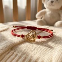 Гривна с червен конец и 14 карата златно сърце с бебешки стъпки Гривна с червен конец и 14 карата златно сърце с бебешки стъпки