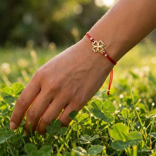 Гривна с червен конец и 14 карата златен елемент детелинка 