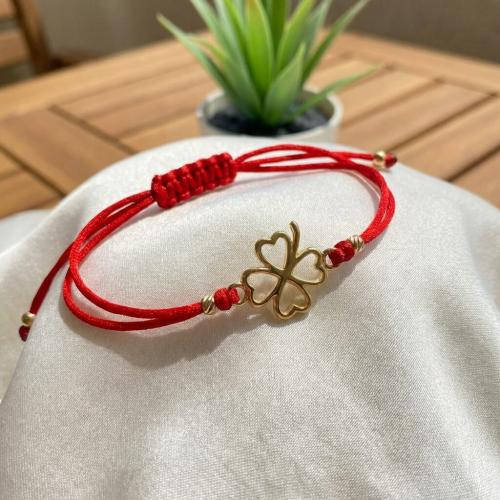 Гривна с червен конец и 14 карата златен елемент детелинка 