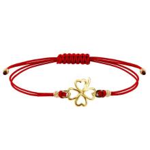 Гривна с червен конец и 14 карата златен елемент детелинка