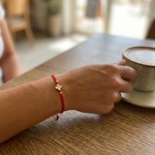 Гривна с червен конец и 14 карата златен елемент кръст Гривна с червен конец и 14 карата златен елемент кръст