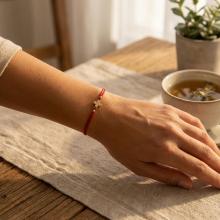 Гривна с червен конец и 14 карата златен елемент кръст Гривна с червен конец и 14 карата златен елемент кръст