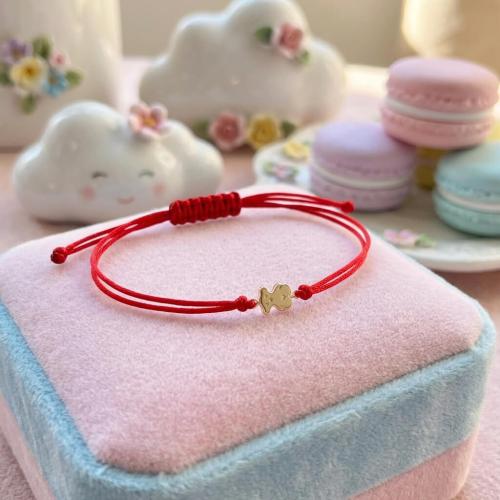 Гривна с червен конец и 14 карата златен елемент мече