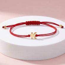 Гривна с червен конец и златни инициали Гривна с червен конец и златни инициали