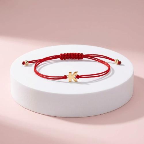 Гривна с червен конец и златни инициали