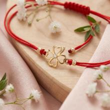 Гривна с червен конец и 14 карата златен елемент детелинка с циркон