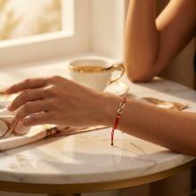 Гривна с червен конец и 14 карата златен елемент безкрайност Гривна с червен конец и 14 карата златен елемент безкрайност