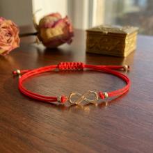 Гривна с червен конец и 14 карата златен елемент безкрайност Гривна с червен конец и 14 карата златен елемент безкрайност