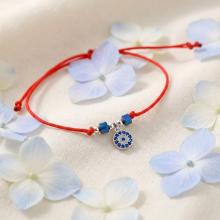 Гривна с червен конец с Dark Heliotrope и сребърен елемент синьо око