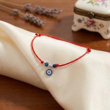 Гривна с червен конец с Dark Heliotrope и сребърен елемент синьо око