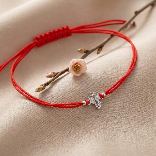 Гривна с червен конец и сребърен елемент ангелче с циркони 